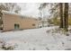 Snow covered backyard with view of house at 6695 Buckhurst Trl, Atlanta, GA 30349