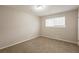 Well-lit bedroom with neutral walls and carpeted floors at 6695 Buckhurst Trl, Atlanta, GA 30349