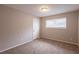 Well-lit bedroom with neutral walls and carpeted floors at 6695 Buckhurst Trl, Atlanta, GA 30349