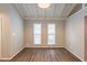 Bright living room with large windows and wood flooring at 6695 Buckhurst Trl, Atlanta, GA 30349