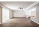 Spacious living room featuring hardwood floors and a ceiling fan at 6695 Buckhurst Trl, Atlanta, GA 30349