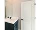 Small bathroom with vanity and white door at 5435 Crestline View Rd, Cumming, GA 30028
