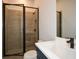 Modern bathroom with a walk-in shower, white sink, and blue vanity at 5435 Crestline View Rd, Cumming, GA 30028