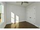 Bright bedroom with hardwood floors, large window, and double doors to closet at 5435 Crestline View Rd, Cumming, GA 30028