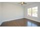 Bright bedroom featuring hardwood floors and a large window at 5435 Crestline View Rd, Cumming, GA 30028