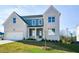 Two-story house with white brick and gray siding, featuring a front porch and attached two-car garage at 5435 Crestline View Rd, Cumming, GA 30028