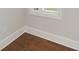 Hardwood floor hallway with white trim and neutral walls at 5435 Crestline View Rd, Cumming, GA 30028