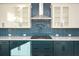Modern kitchen features gas cooktop and blue herringbone tile backsplash at 5435 Crestline View Rd, Cumming, GA 30028