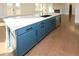 Island kitchen with white quartz countertops and blue cabinetry at 5435 Crestline View Rd, Cumming, GA 30028
