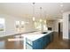Open concept kitchen boasts a large island, stainless steel appliances, and blue cabinetry at 5435 Crestline View Rd, Cumming, GA 30028