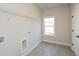 Laundry room with overhead shelving and tile floor at 5435 Crestline View Rd, Cumming, GA 30028