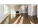 Sunlit living room with hardwood floors and a stone fireplace at 5435 Crestline View Rd, Cumming, GA 30028