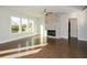 Bright living room with hardwood floors, fireplace, and large windows at 5435 Crestline View Rd, Cumming, GA 30028