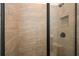 Clean shower with neutral tile and black accents at 5435 Crestline View Rd, Cumming, GA 30028