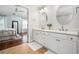 Bathroom featuring double sinks, tile flooring, and a bedroom view at 570 Parkside Village Nw Way # 12, Marietta, GA 30060