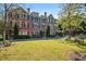 Exterior view of well-maintained townhome with black shutters and beautiful landscaping at 570 Parkside Village Nw Way # 12, Marietta, GA 30060