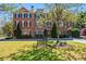 Attractive townhome featuring brick facade, a bench and manicured landscaping at 570 Parkside Village Nw Way # 12, Marietta, GA 30060