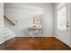 Inviting foyer with gleaming hardwood floors, a console table, and a staircase leading to the upper level at 570 Parkside Village Nw Way # 12, Marietta, GA 30060