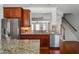 Well-equipped kitchen with stainless steel appliances, granite countertops, wood cabinets, and hardwood floors at 570 Parkside Village Nw Way # 12, Marietta, GA 30060