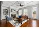 Bright living room featuring a fireplace, built-in shelving, coffered ceiling, and hardwood floors at 570 Parkside Village Nw Way # 12, Marietta, GA 30060