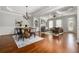Open concept living room and dining room featuring beautiful hardwood floors, lots of natural light, and a cozy fireplace at 570 Parkside Village Nw Way # 12, Marietta, GA 30060