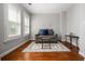 Sitting room includes gray couch, wood flooring, and natural lighting at 570 Parkside Village Nw Way # 12, Marietta, GA 30060