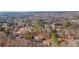 Aerial view of a neighborhood with houses surrounded by trees at 7825 Brands Hatch Blvd, Cumming, GA 30040