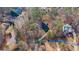 Aerial view of a house and lot in a wooded neighborhood at 7825 Brands Hatch Blvd, Cumming, GA 30040