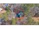 House nestled in woods with a long driveway, seen from above at 7825 Brands Hatch Blvd, Cumming, GA 30040