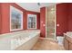 Bathroom boasts a bathtub, shower, and updated tile floors at 7825 Brands Hatch Blvd, Cumming, GA 30040