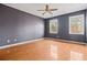 Spacious bedroom with hardwood floors and two windows at 7825 Brands Hatch Blvd, Cumming, GA 30040