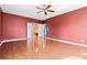 Hardwood floor bedroom with access to bathroom and upper floor at 7825 Brands Hatch Blvd, Cumming, GA 30040