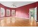 Large bedroom with hardwood floors and plenty of natural light from bay windows at 7825 Brands Hatch Blvd, Cumming, GA 30040