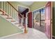 Two-story entryway with hardwood stairs and access to back deck at 7825 Brands Hatch Blvd, Cumming, GA 30040