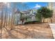 Green two-story house with a turret, situated on a wooded lot at 7825 Brands Hatch Blvd, Cumming, GA 30040