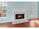 White marble fireplace with gas logs in light blue room at 7825 Brands Hatch Blvd, Cumming, GA 30040