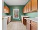 Laundry room with wooden cabinets and tiled floor at 7825 Brands Hatch Blvd, Cumming, GA 30040