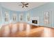Sunlit living room with hardwood floors, fireplace, and access to deck at 7825 Brands Hatch Blvd, Cumming, GA 30040