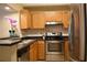 Modern kitchen with stainless steel appliances and wood cabinets at 32 Peachtree St # 403, Atlanta, GA 30303