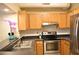 Modern kitchen with stainless steel appliances and wood cabinets at 32 Peachtree St # 403, Atlanta, GA 30303