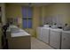 Shared laundry facility with multiple washers and dryers at 32 Peachtree St # 403, Atlanta, GA 30303