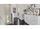 Stylish hallway with wet bar, dark hardwood floors and modern art at 456 Parkway Ne Dr # 12, Atlanta, GA 30308
