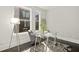 Bright home office features a glass desk, comfortable chair, and large windows at 456 Parkway Ne Dr # 12, Atlanta, GA 30308