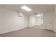 Large empty basement room with neutral walls and flooring at 9635 Haverhill Ln, Johns Creek, GA 30022