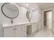 Elegant bathroom with double vanity, marble tile, and large mirrors at 9635 Haverhill Ln, Johns Creek, GA 30022