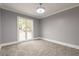 Bright bedroom featuring gray walls, carpet, and a window at 9635 Haverhill Ln, Johns Creek, GA 30022