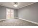Spacious bedroom with gray walls, carpet, and window views at 9635 Haverhill Ln, Johns Creek, GA 30022