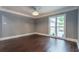 Bright dining room with hardwood floors and large window at 9635 Haverhill Ln, Johns Creek, GA 30022