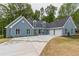 Two-story house with gray siding, three-car garage, and large driveway at 9635 Haverhill Ln, Johns Creek, GA 30022