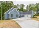 Two-story house with gray siding, three-car garage, and large driveway at 9635 Haverhill Ln, Johns Creek, GA 30022